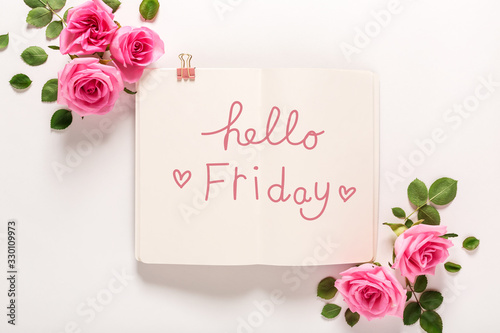 Fototapeta Naklejka Na Ścianę i Meble -  Hello Friday message with roses and leaves top view flat lay
