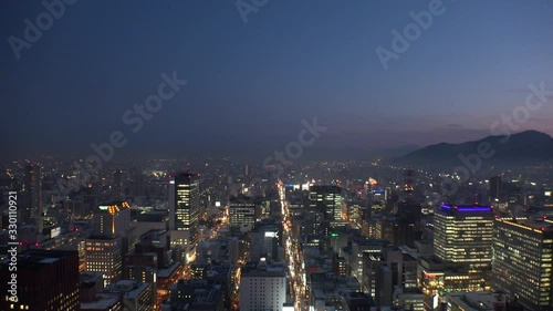Wallpaper Mural SAPPORO, HOKKAIDO, JAPAN - FEB 2020 : Aerial high angle view of cityscape of Sapporo city in sunset time. View of buildings and street traffic around Susukino downtown area. Torontodigital.ca