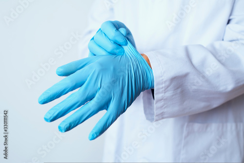 doctor man putting on surgical gloves photo