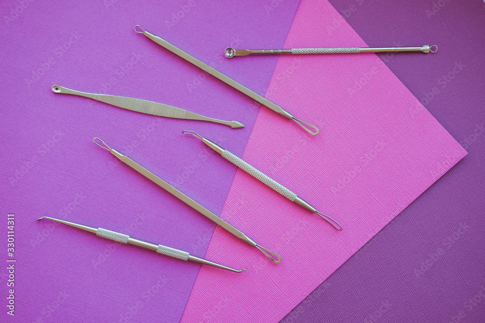 Tools for removing acne. Tools of the cosmetologist for problem skin on pink paper background. Tools for removing acne. Tools of the cosmetologist for problem skin on pink paper background.