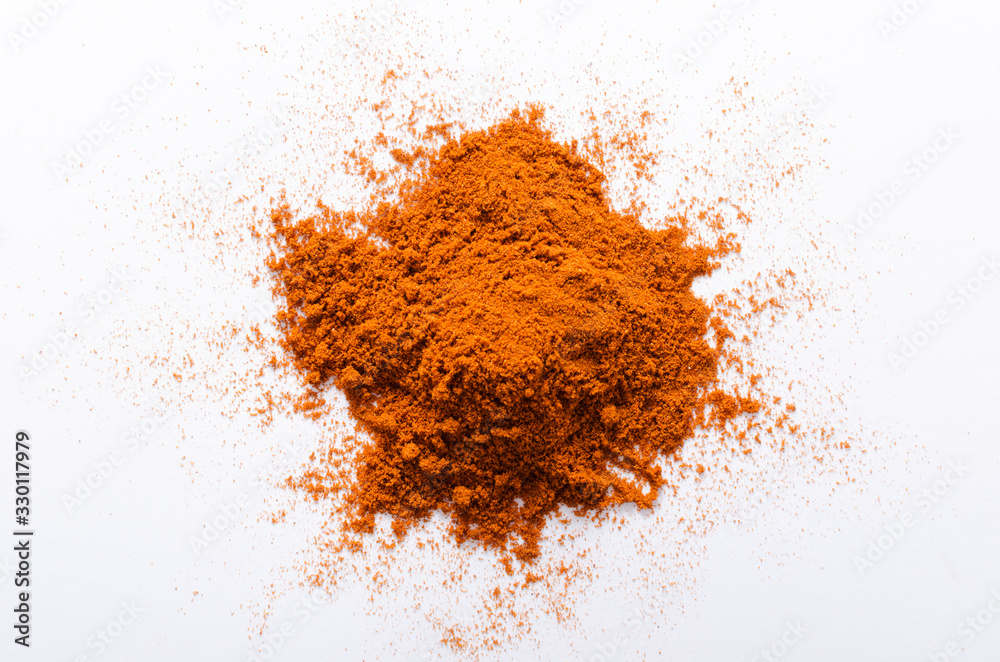 Top view of red pepper powder on the white background Top view of red pepper powder on the white background
