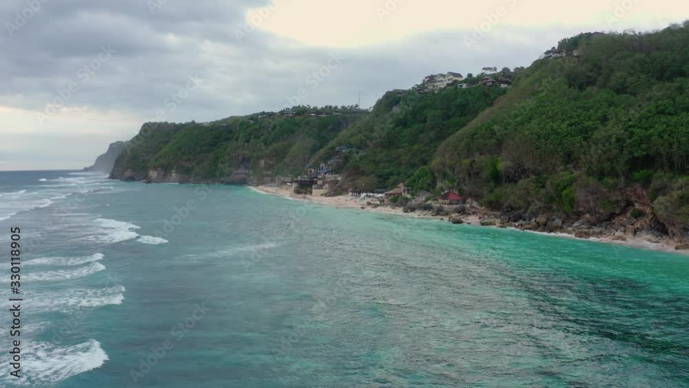 motion above turquoise ocean water to narrow sand beach motion above turquoise ocean water to narrow sand beach