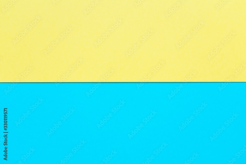 Bright yellow and sky blue cardboard background, horizontal division Bright yellow and sky blue cardboard background, horizontal division