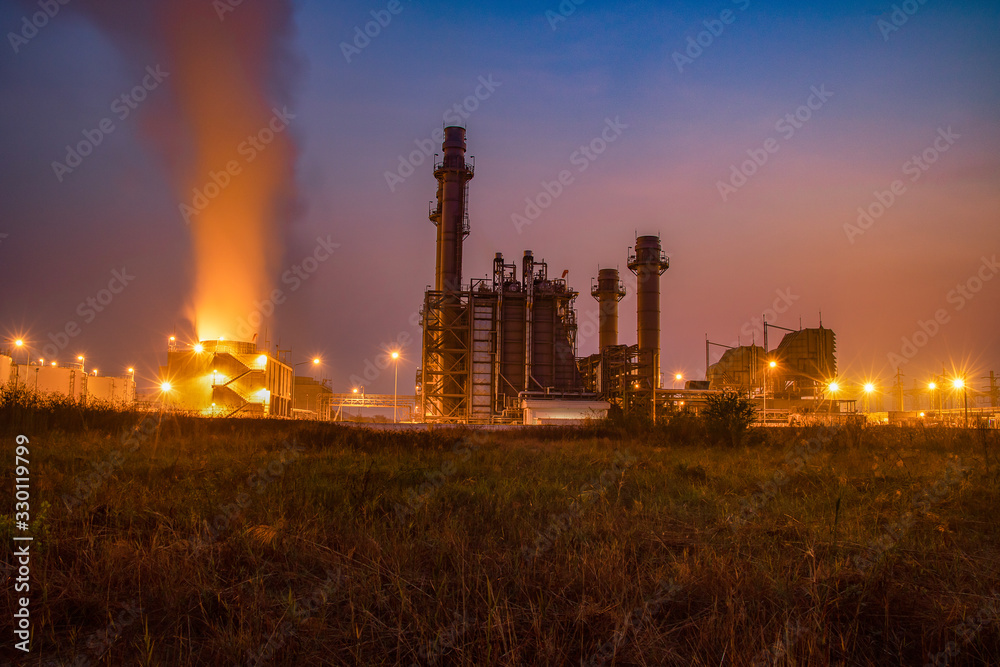 Natural Gas Combined Cycle Power Plant with sunset and light orange