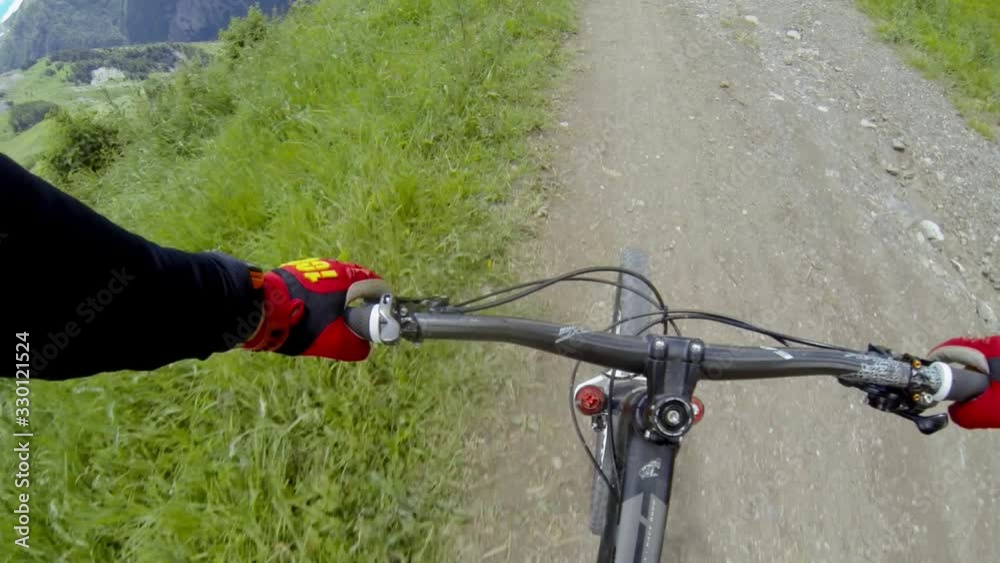 POV mountain bike riding, downhill biking. Hands of rider. Sport biker driving. Descent on special trail going down POV mountain bike riding, downhill biking. Hands of rider. Sport biker driving. Descent on special trail going down