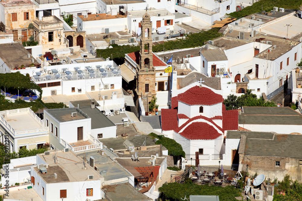 Lindos, Rhodes / Greece - June 23, 2014: View on the roofs of Lindos with Agia Panagia church, Rhodes, Dodecanese Islands, Greece.