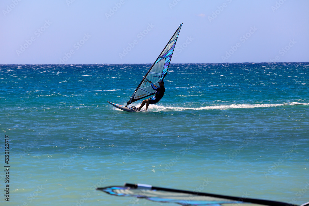 Naklejka premium Prasonissi, Rhodes / Greece - June 23, 2014: Surfer at Cape of Akra Prasonisi, Rhodes, Dodecanese Islands, Greece.