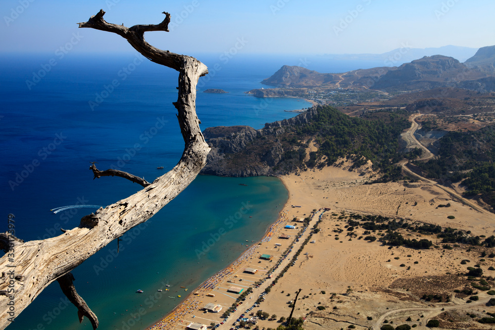Tsampika, Rhodes / Greece - June 23, 2014: Tsampika beach view and surrounding mountains on the east coast, Rhodes, Dodecanese Islands, Greece...... Tsampika, Rhodes / Greece - June 23, 2014: Tsampika beach view and surrounding mountains on the east coast, Rhodes, Dodecanese Islands, Greece......