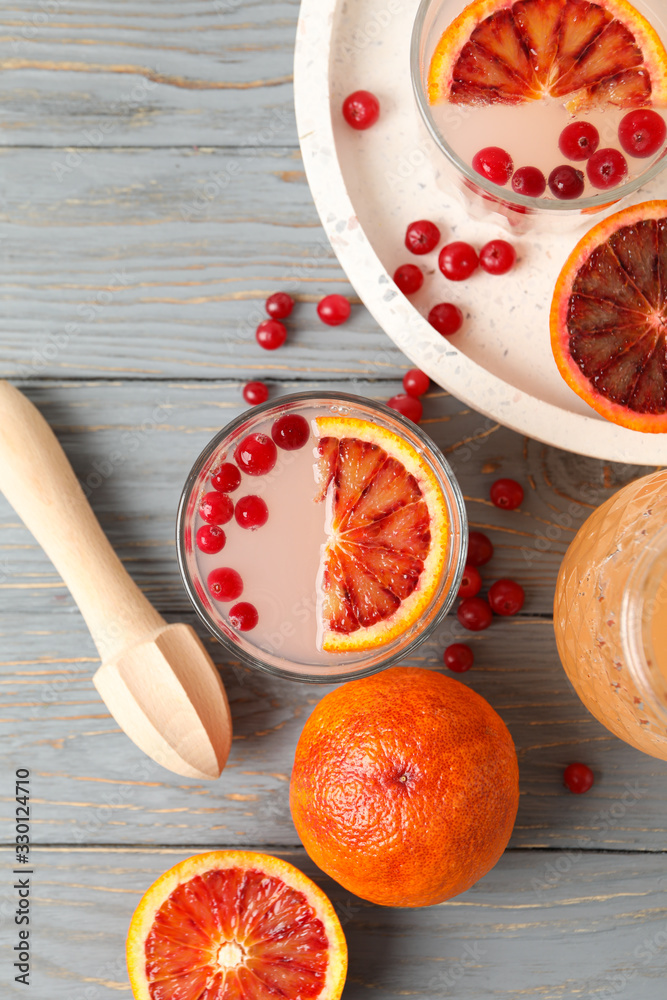 Lemonade, red orange and cranberry on wooden background, top view Lemonade, red orange and cranberry on wooden background, top view