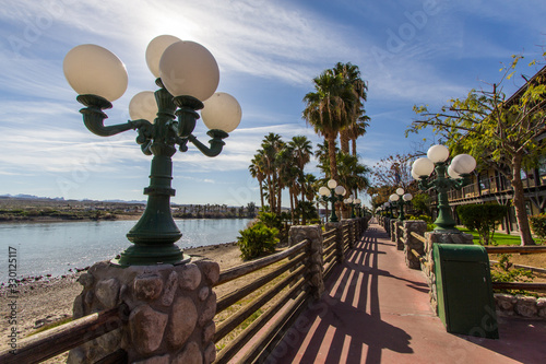 Riverwalk In Laughlin Nevada. Streetlights and palm trees line the empty  riverwalk along the Colorado River in the downtown Laughlin Nevada casino district.  photo