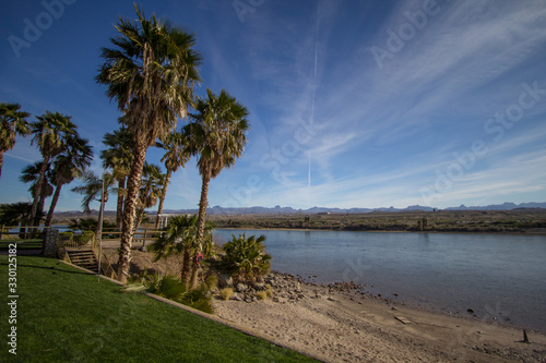 Laughlin Nevada Waterfront. Beach with a grove of palm trees on the Colorado River in the waterfront district of Laughlin Nevada.