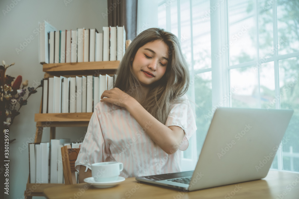 Lazy bored asian woman using laptop in the morning. Lazy bored asian woman using laptop in the morning.