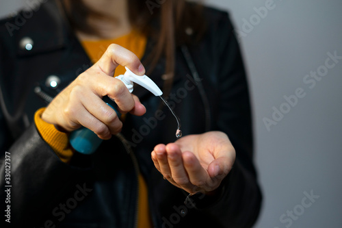 Wallpaper Mural Woman putting disinfectant gel on her hands. Torontodigital.ca