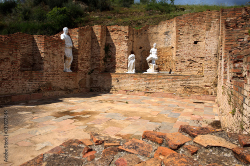 Roselle (GR), Italy - June 19, 2017: Etruscan ruins and statue in archaeological site in Roselle, Grosseto, Tuscany, Italy, Europe