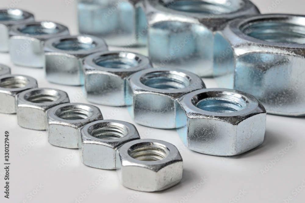 Big and small screw-nut. Concept. White background. Big and small screw-nut. Concept. White background.