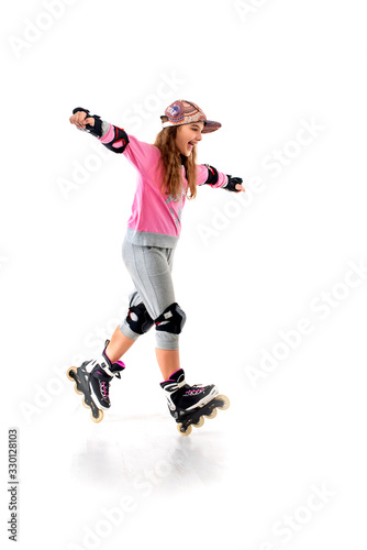 A young teenager girl wearing tracksuit and defense rollerblading fun.
