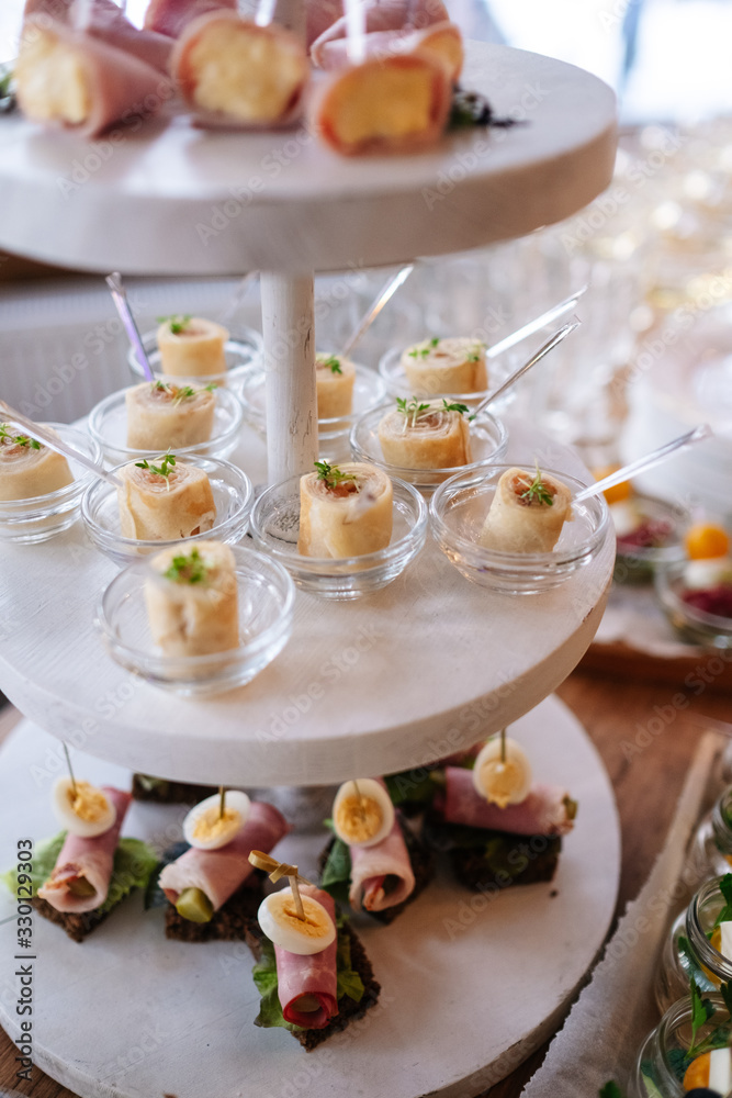 Glasses with seafood snacks and meat on banquet table Glasses with seafood snacks and meat on banquet table