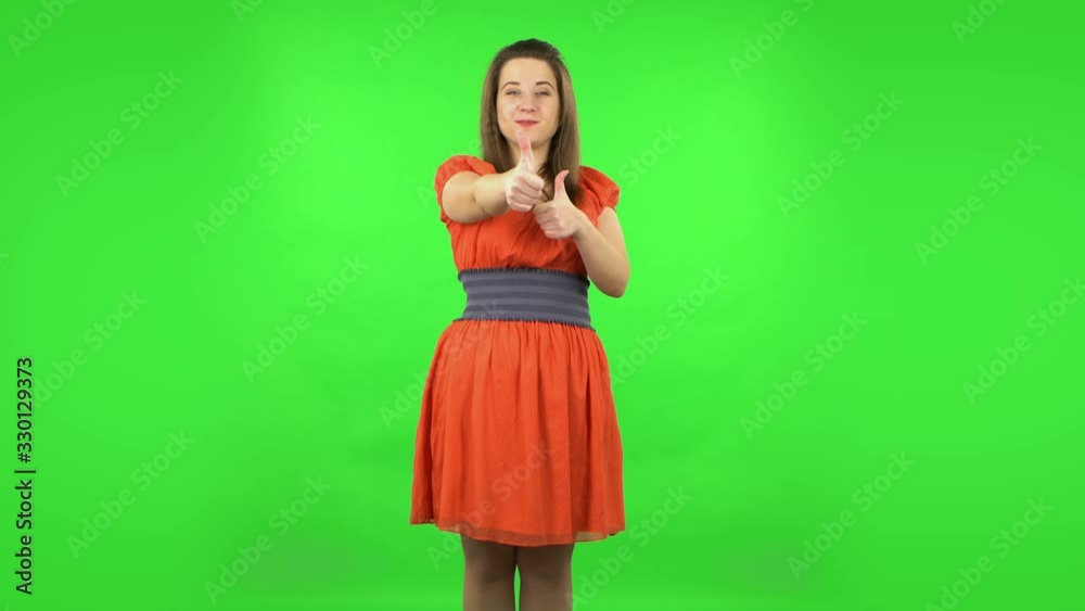 Cute girl showing thumbs up, gesture like. Green screen Cute girl showing thumbs up, gesture like. Green screen