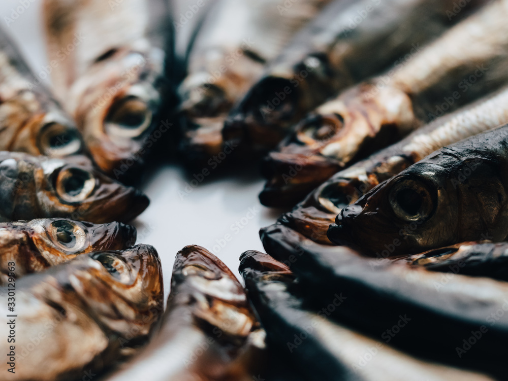 Cold smoked salaka ready to eat. Smoked fish close-up on a plate. Sea fish is a tasty and healthy natural food product, rich source of essential Omega-6 fatty acids or polyunsaturated fat acid oil