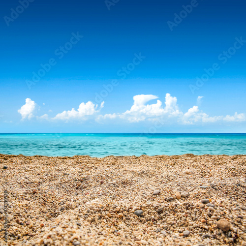 Summer background of sand and sea.Blue sunny sky and warm day. 