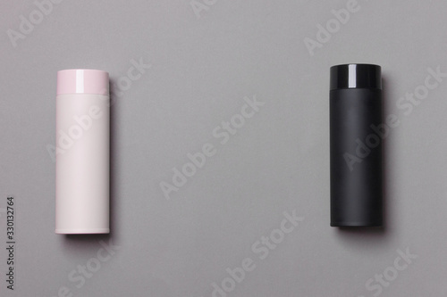 black and pink thermos cup on grey background with copy space