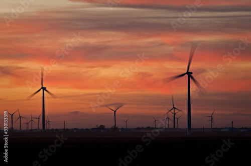 Sunset on a wind farm generating clean energy.