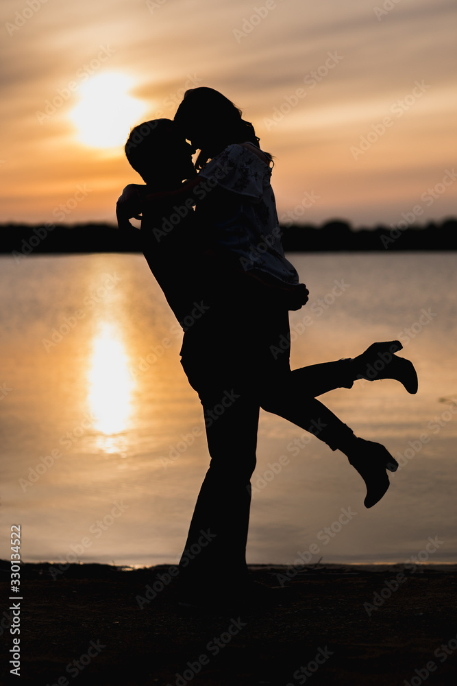Couple during their engagement session at sunset