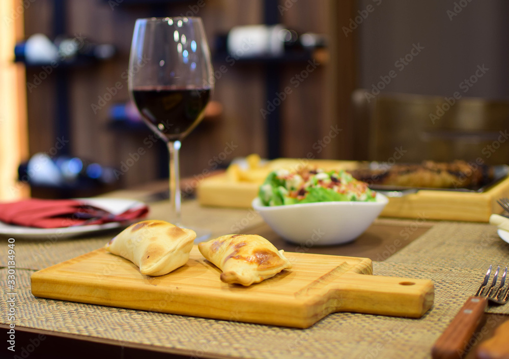 Argentine empanadas with a glass of wine and salads Argentine empanadas with a glass of wine and salads