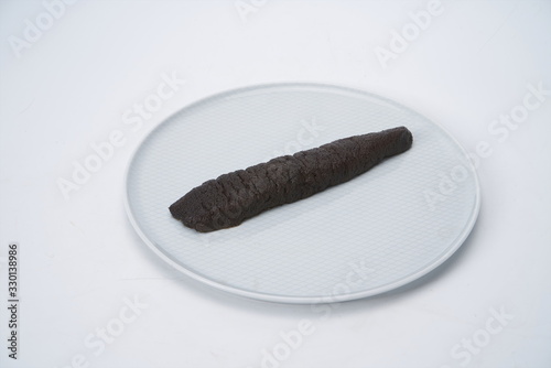 After the fresh sea cucumber is cut with a knife, it is under the white background