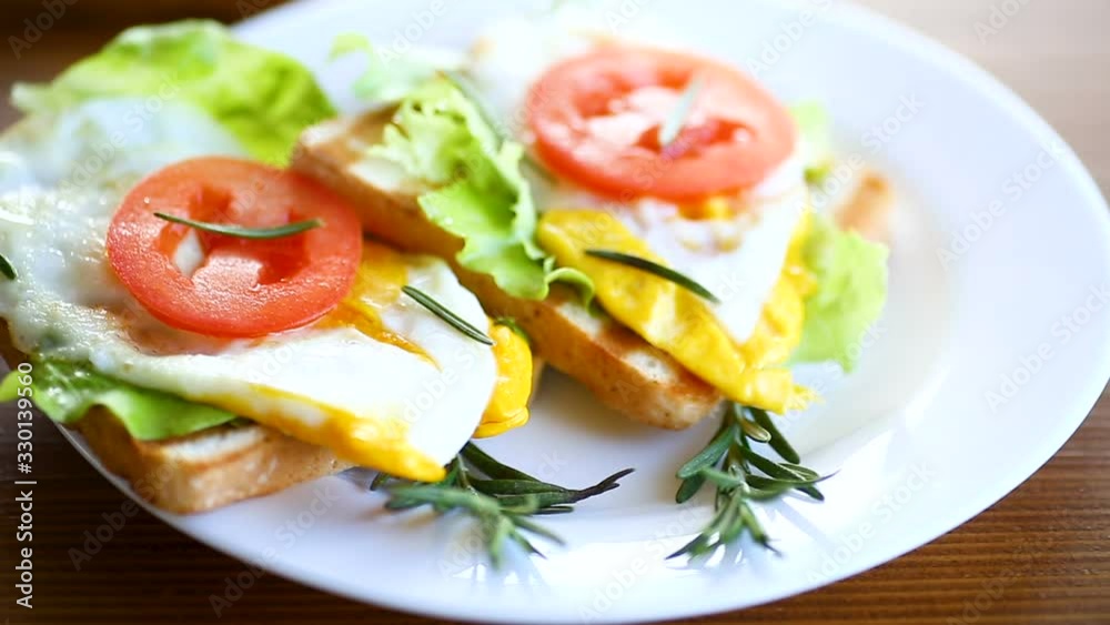fried toasts with egg, salad, tomato in a plate fried toasts with egg, salad, tomato in a plate