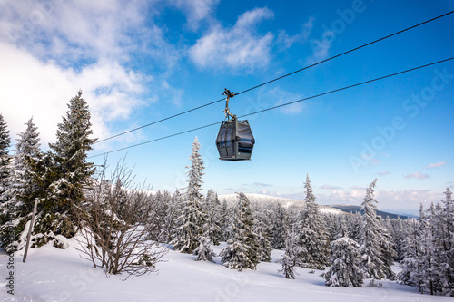 Cable car. Beautiful winter landscape with snow covered trees and cable car travel. Krkonose, Pec pod Snezkou. photo