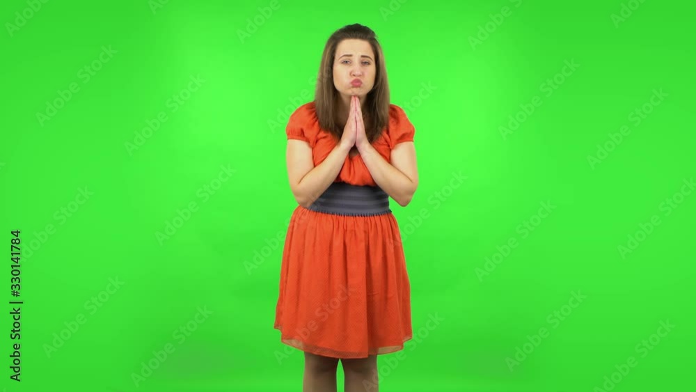Cute girl keeping palm together and asking for something . Green screen Cute girl keeping palm together and asking for something . Green screen