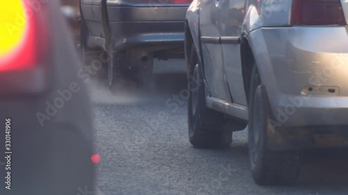 Cars in traffic. Exhaust fumes from the exhaust pipe