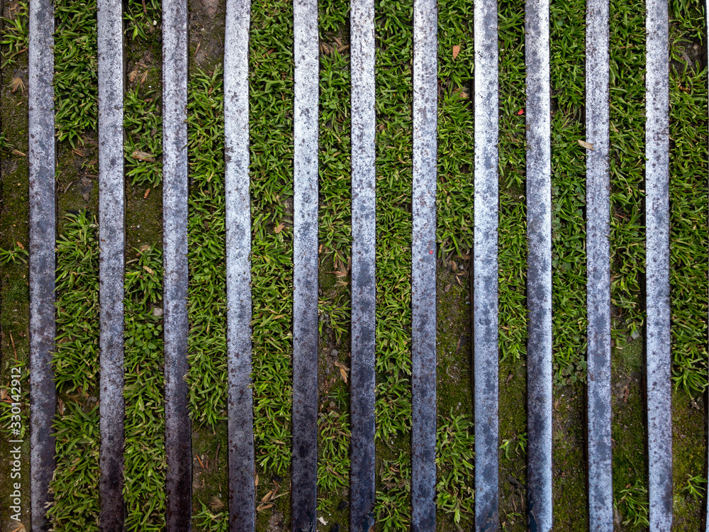 iron beams with green grass used for background and texture. iron beams with green grass used for background and texture.