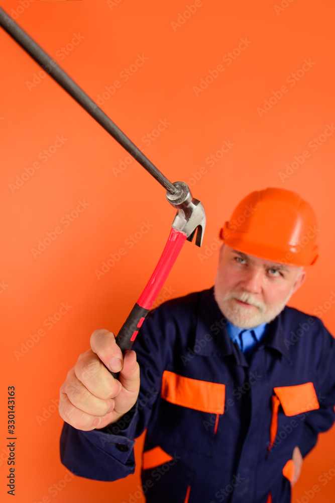 Hammer and nails. Repairment tools. Builder. Worker. Worker hammers nails. Repair man. Engineer. Hard hat. Selective focus. Advertising.