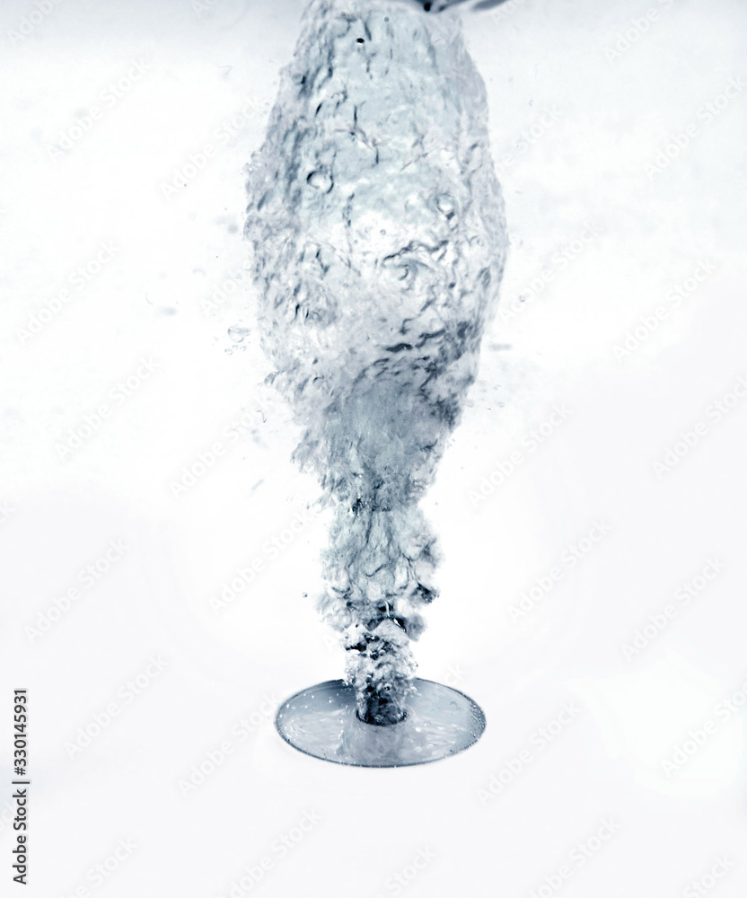 A nozzle blows air up under water in a bath tub. A nozzle blows air up under water in a bath tub.