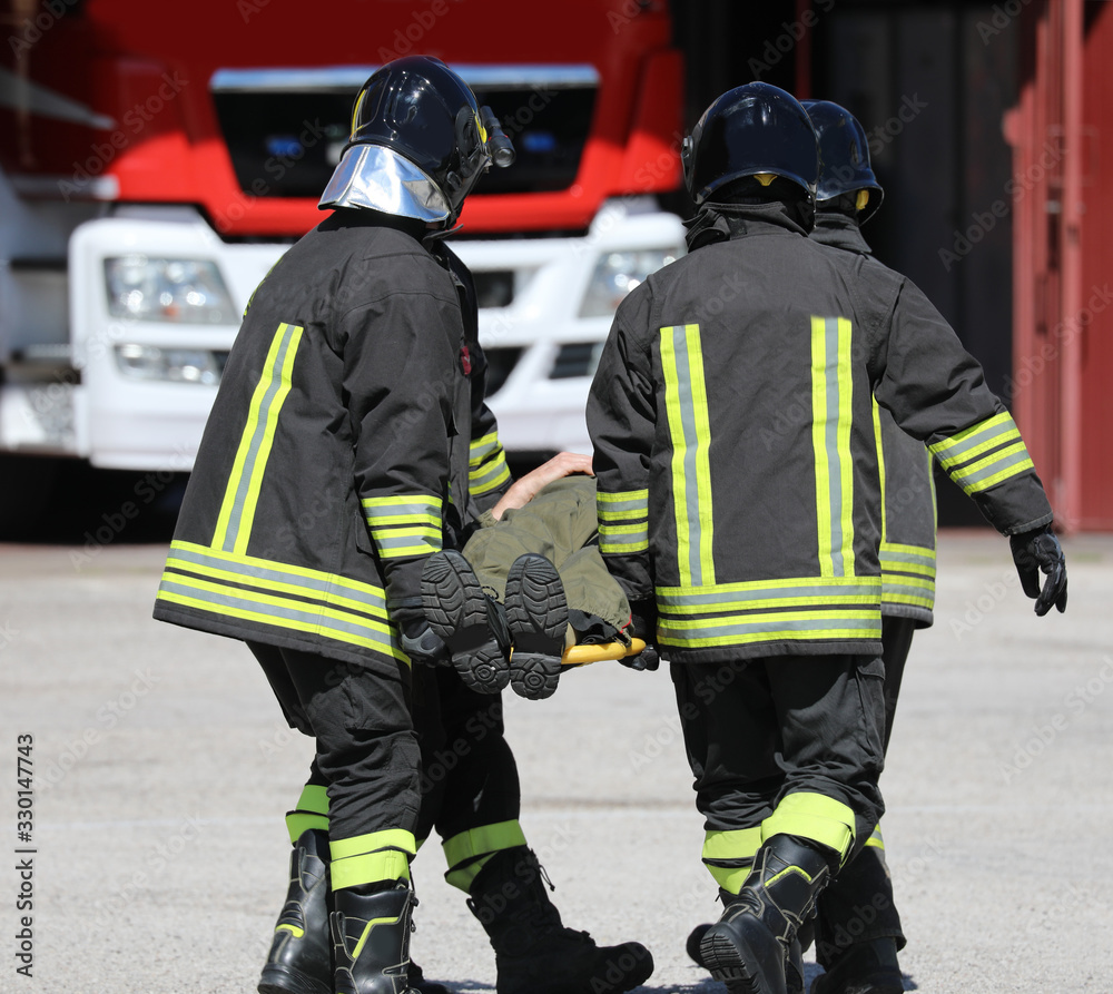 firefighters and a stretcher with person firefighters and a stretcher with person