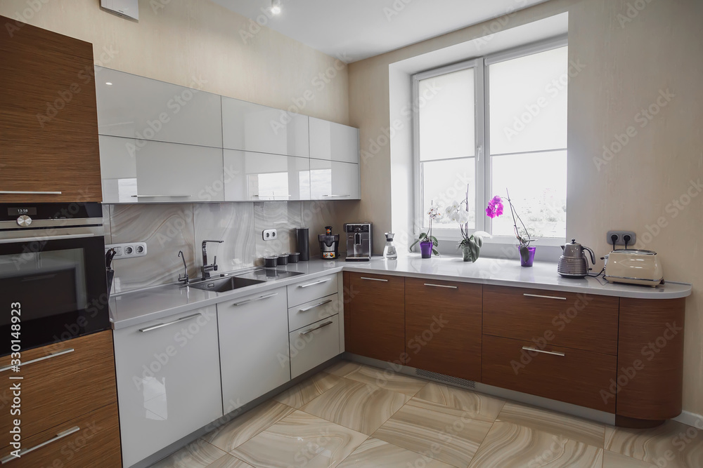 View of luxury modern fitted kitchen with stainless steel appliances View of luxury modern fitted kitchen with stainless steel appliances
