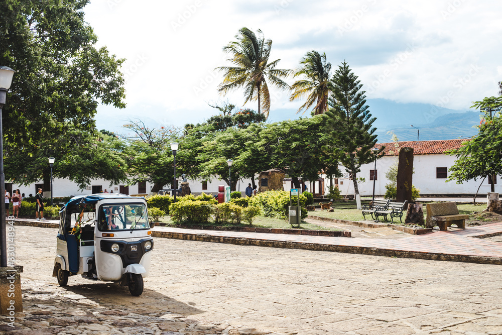 Tuktuk waits for a passenger on the edge of the main square plaza of Guane, a small typical town in the Santander region of Colombia
