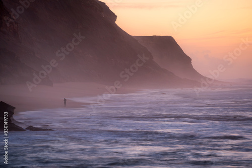 Fishermen in Santa Cruz beach at sunset  in Portugal