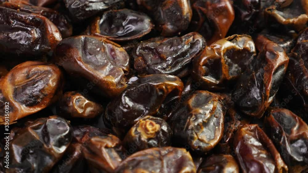 Dates fruit background. Dried date, closeup. Nobody. Top view. Rotate Dates fruit background. Dried date, closeup. Nobody. Top view. Rotate