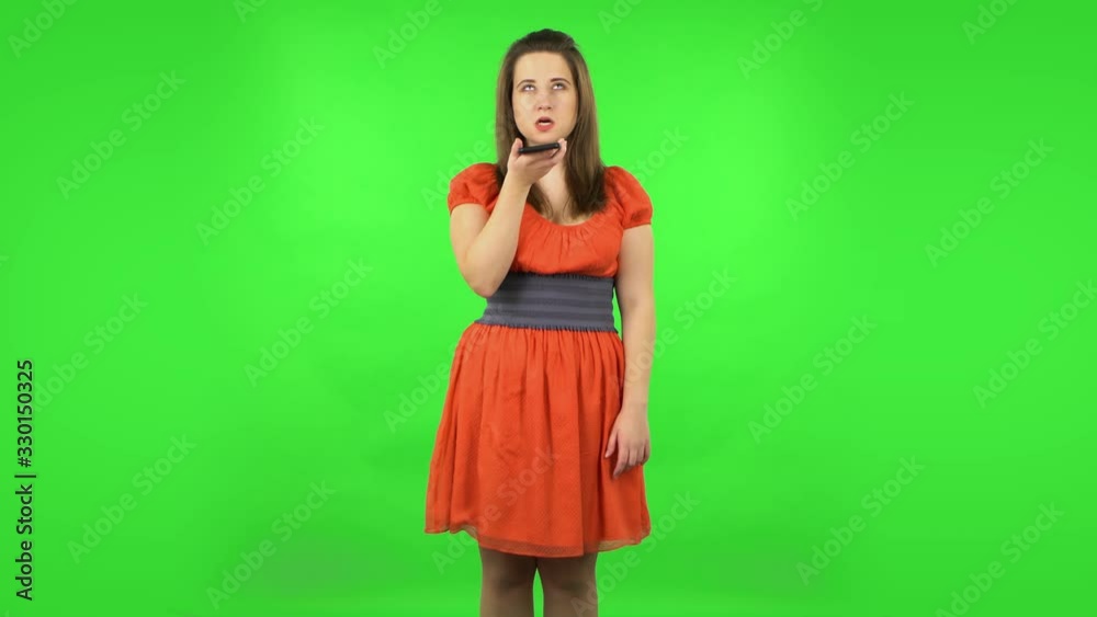 Cute girl asking for information on the network via phone. Green screen Cute girl asking for information on the network via phone. Green screen