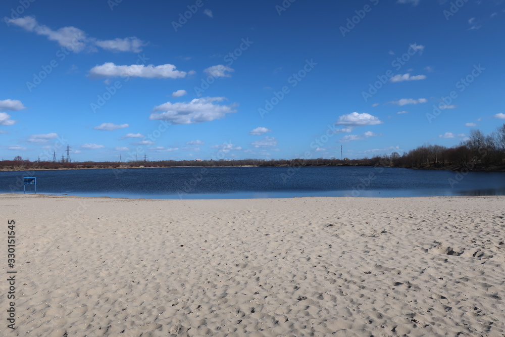 a beautiful landscape with a blue sky combined with a blue river and white sand