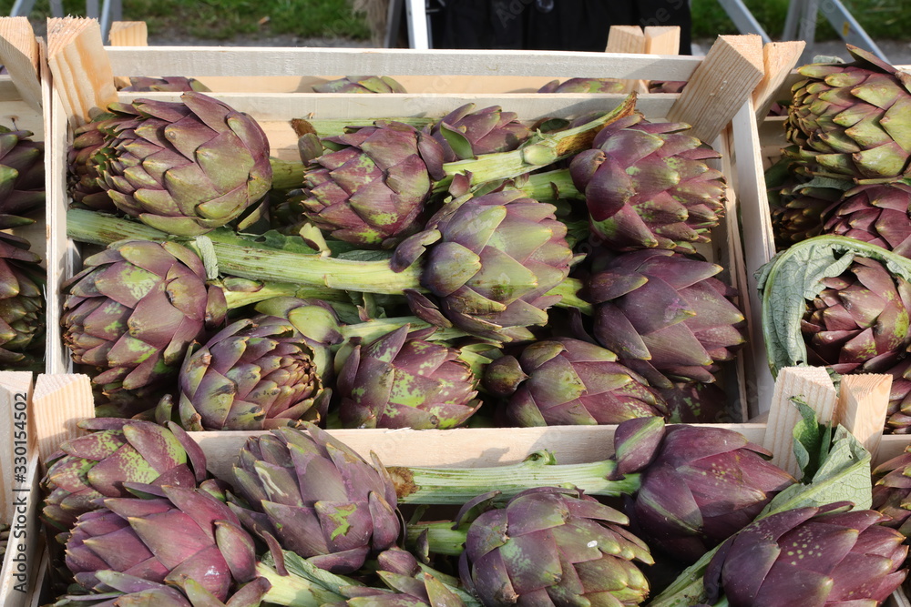 Obraz premium boxes of big ARTICHOKES for sale in the greengrocer stall at the
