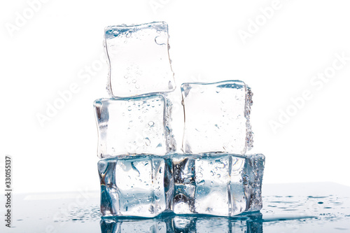 ice cubes and water drops close up on blue and white background