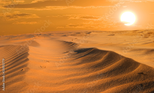 dramatic red sunset over the wide sandy desert  good outdoor background