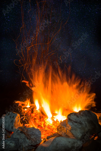 closeup camp fire at the night on a starry sky background