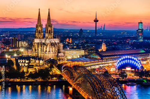 Beautiful night landscape of the gothic Cologne cathedral  Hohenzollern Bridge and the River Rhine at sunset and blue hour in Cologne  Germany