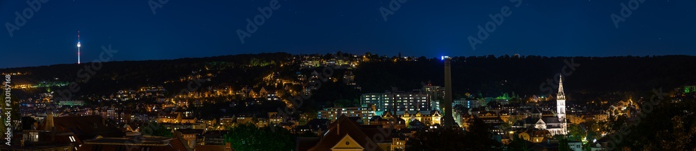 Germany, XXL panorama of of stuttgart heslach houses, television tower and illuminated church of matthew by night under starry sky, scenic view from above