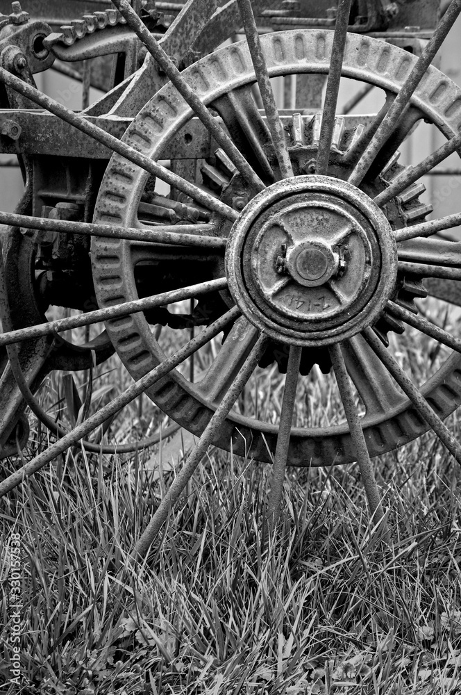 Iron wheel detail of 1890's farm machinery.